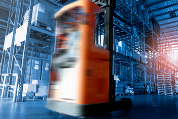 motion speeding blurred of forklift working in interior of storage warehouse, warehouse,business cargo logistics