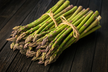Bunch of fresh asparagus on wooden table