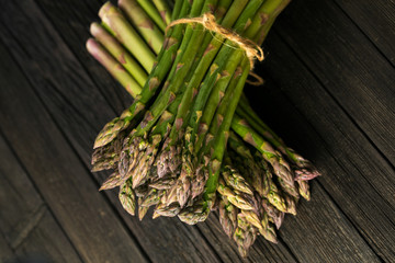 Bunch of fresh green asparagus spears on a rustic wooden table