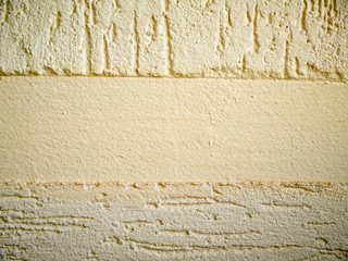Yellow wall plastered with putty bark beetle different directions with non-plastered flat empty...