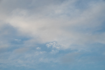 white-gray smoky clouds against the blue sky