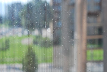 rain drops on the window, behind it's a suburb in Sarajevo