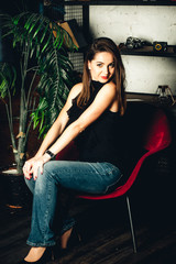 beautiful and stylish girl on the armchair