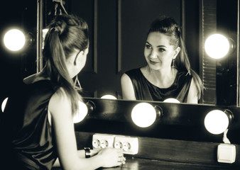 beautiful and stylish girl near the mirror