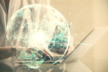 Double exposure of business theme sketch hologram and woman holding and using a mobile device.