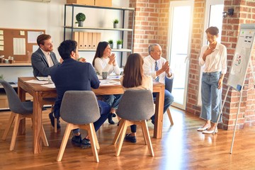 Group of business workers working together in a meeting. One of them making presentation to colleagues at the office