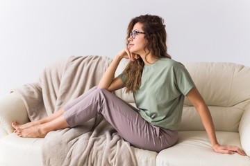 Obraz premium Coronavirus, Covid-19, Quarantine, isolation, coronavirus pandemic world. Stay at home. Bored woman spending time sitting on sofa at home.