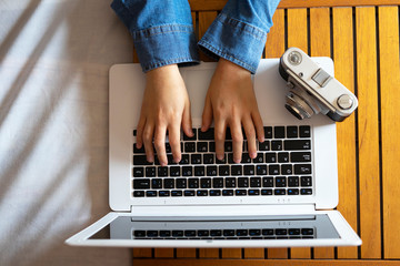 Photographer working from home with her computer and camera. Online photography tutorial Concept.