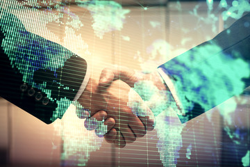 Double exposure of business theme hologram and handshake of two men. Success concept.