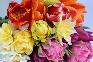 Original composition of assorted bright tulips and daffodils