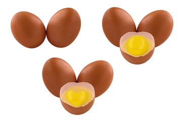 Chicken eggs isolated on a white background, two whole eggs and half a broken egg with a heart-shaped yolk.