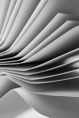 Curved sheets of paper in black and white detail - background