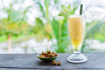 A cold smoothie is a cocktail of fresh tropical fruits and nuts in a small Cup.