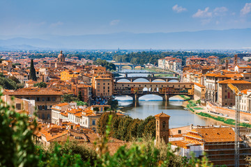 Fototapeta na wymiar Aerial view of the Arno river and its bridges. Beautiful city landscape of Florence.