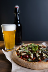 Fototapeta na wymiar Beer glass and Pizza on wood table