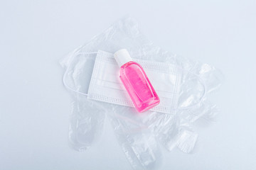 Hygienic set of disposable plastic gloves, bottle with antiseptic sanitizer gel and protective medical mask. Hygiene products. Protection during the coronavirus epidemic. Copy space for text, flat lay