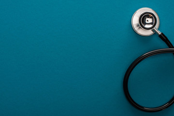 Fototapeta na wymiar top view of stethoscope on blue background