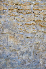 Fragment of an old masonry. Natural stone limestone.