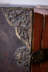 Large old leather book with metal corners and lock. Shallow depth of field.