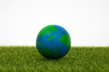 Fototapeta na wymiar globe on green grass with white background