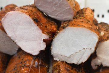 Assorted meat products, sausages, chorizo, spices on a dark table. View from above.