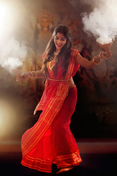 Bengali Married women performing dhunuchi dance on the occasion of durga puja
