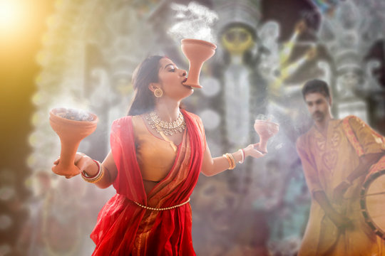 Bengali Married women performing dhunuchi dance on the occasion of durga puja

