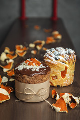 Different types of Easter cakes and tangerine zest on wooden table