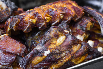 Marinated pork spare ribs, stack or pile of fresh grilled meat during barbeque, BBQ concept.