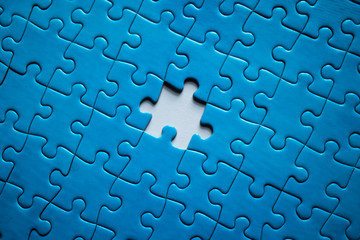 Incomplete blue-piece puzzle with a missing piece