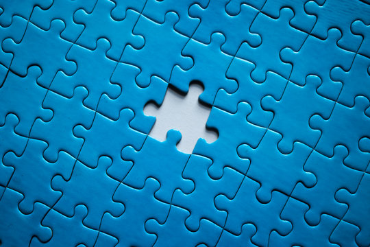Incomplete blue-piece puzzle with a missing piece