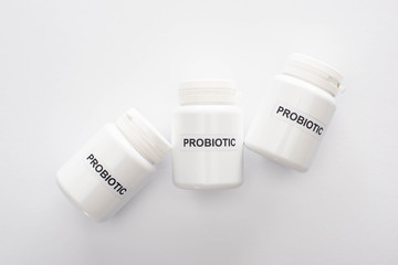 top view of containers with probiotic lettering on white background