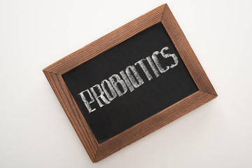 top view of chalkboard with probiotics lettering on white background