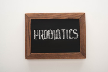 top view of chalkboard with probiotics lettering on white background