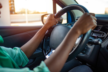 Portrait of African Woman Sitting In Car. Cropped shot of an unrecognizable woman driving her car....