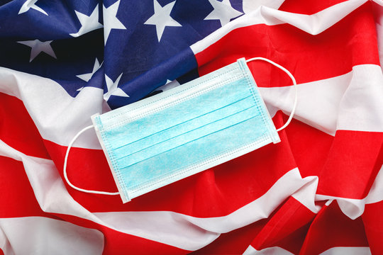 Coronavirus in USA. Protective surgical face mask on American national flag. U.S. flag and hygienic mask as symbol of protection prevention viral infection coronavirus, Covid-19. Medicine health care