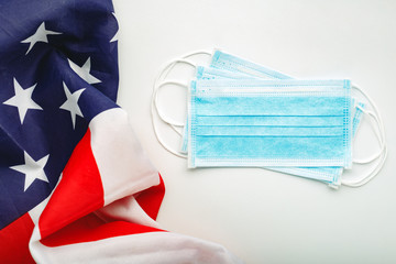 Coronavirus in USA. Protective surgical face mask on American national flag. U.S. flag and hygienic mask as symbol of protection prevention viral infection coronavirus, Covid-19. Medicine health care