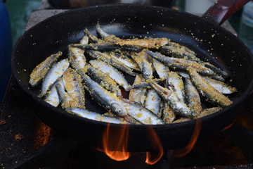 Freshly grilled fish on counter top stall, during seafood festival, street food market.