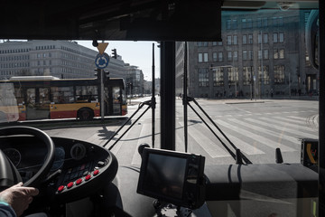 Street view through the windshield of the bus
