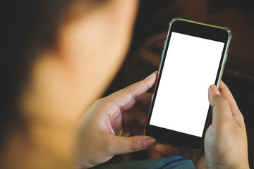 Cropped shot view of man hands holding smart phone with blank copy space screen for your text message or information content, female reading text message on cell telephone during in urban setting. 