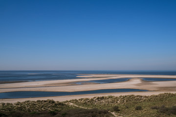 Fototapeta na wymiar Dutch landscape, North sea sandy beach during low tide near the second Maasvlakte, spring in Netherlands