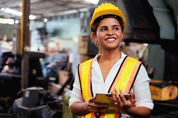 Industry maintenance engineer woman dark skin wearing uniform and safety helmet under inspection...
