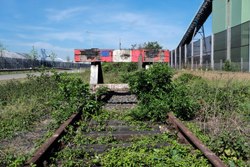 wooden buffer stop with red stop sign ending rail tracks concept for limit. Buffer stop . The final...