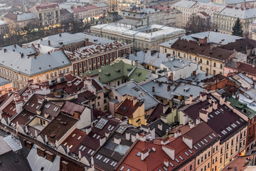 Fototapeta premium Top view from Lviv city hall tower. A lot of buildings roofs, towers, architecture, streets, tenement houses.