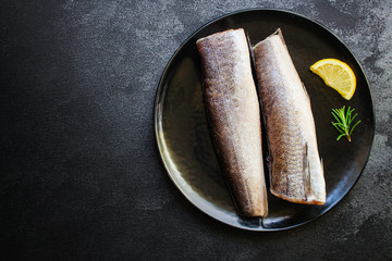 fish raw hake (set of ingredients for cooking). food background. top view. copy space ketogen or paleo diet pascarian