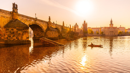 Fototapeta premium Fishing under Charles Bridge, Czech: Karluv most. Sunny morning on Vltava River. Prague, Czech Republic
