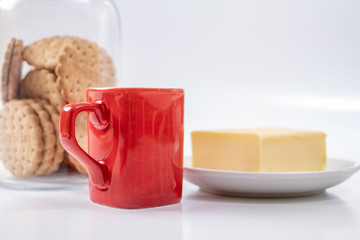 red coffee cup with cookies on background