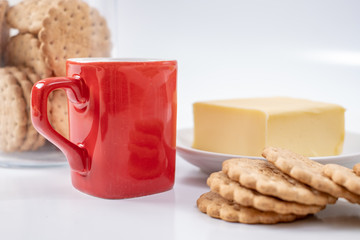red coffee cup with cookies on background