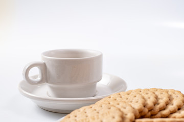 white cup of coffee with cookies on background