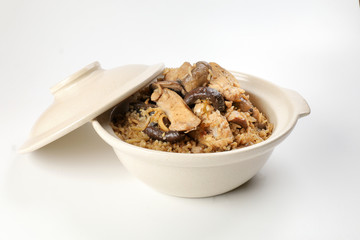Clay pot chicken rice with mushroom in clay ceramic bowl on white background